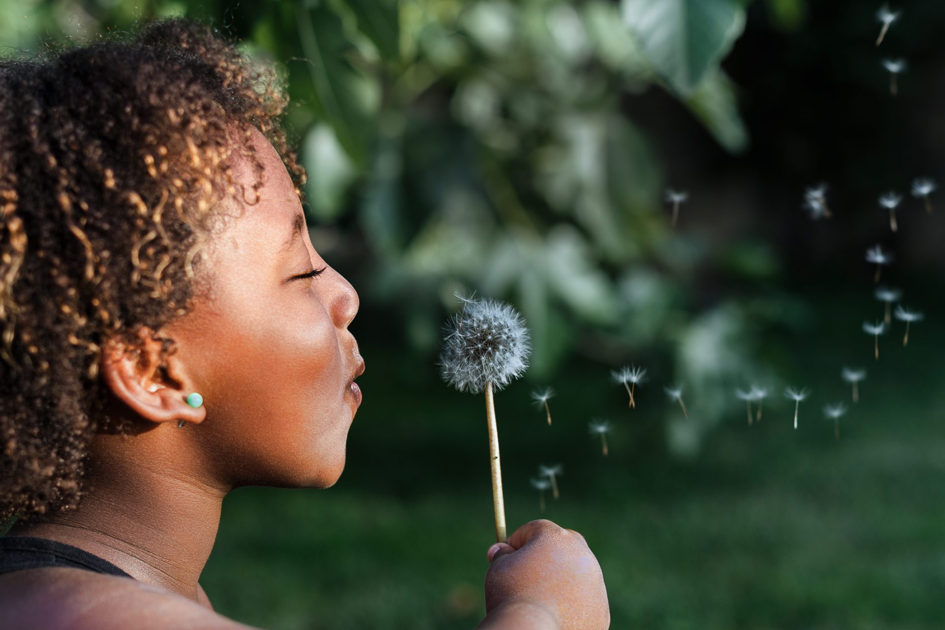 Girl blowing dandelion